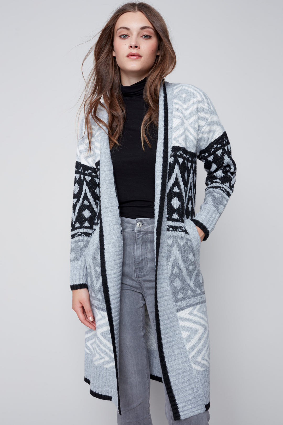 Take your style to a whole new level with this long jacquard cardigan adorned with an intricate geometric design. Its stunning aztec pattern says fall and winter, while its pockets make it as functional as it is fashionable. 