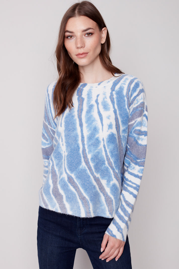 Featuring a reversible round neck sweater printed with a stunning, colorful long stripe pattern, this versatile top is perfect for brightening up any closet. I