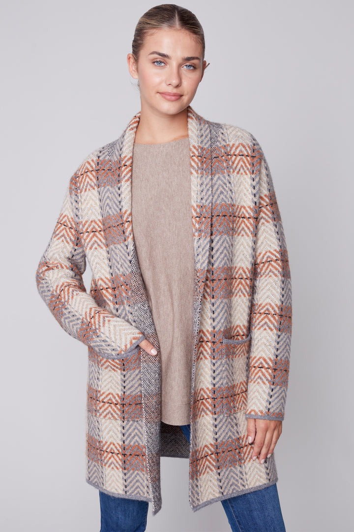 Look fashionable and stay warm in this fall Chevron Check Cardigan. This understated cardigan features a fringed shawl collar and is cut to hug your curves for a flattering, stylish look. Its chic chevron check design is both warm and refreshing.
