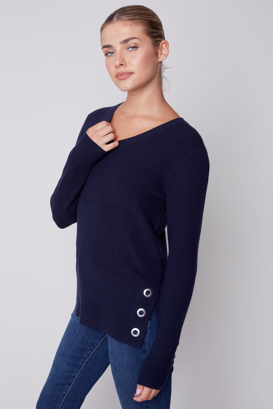Stay cozy yet look stylish with this V-neck top with grommets! The plushy knit and grommet detail combine to create an elegant, solid look that will take any outfit up a notch. Look fashionable while feeling comfortable all day long!