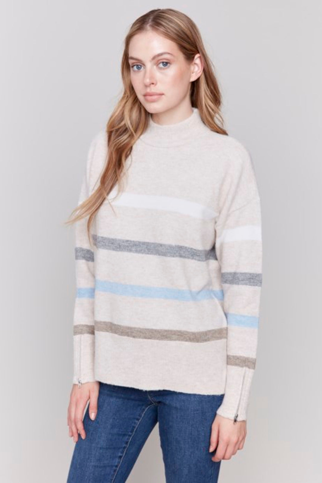 Charlie B Fall 2024 With a smart stripe design pattern and a contrast mock neck that steals the show, this sweater is anything but ordinary! The zipper cuffs add a unique touch while keeping you stylish and comfortable on cooler early fall days.