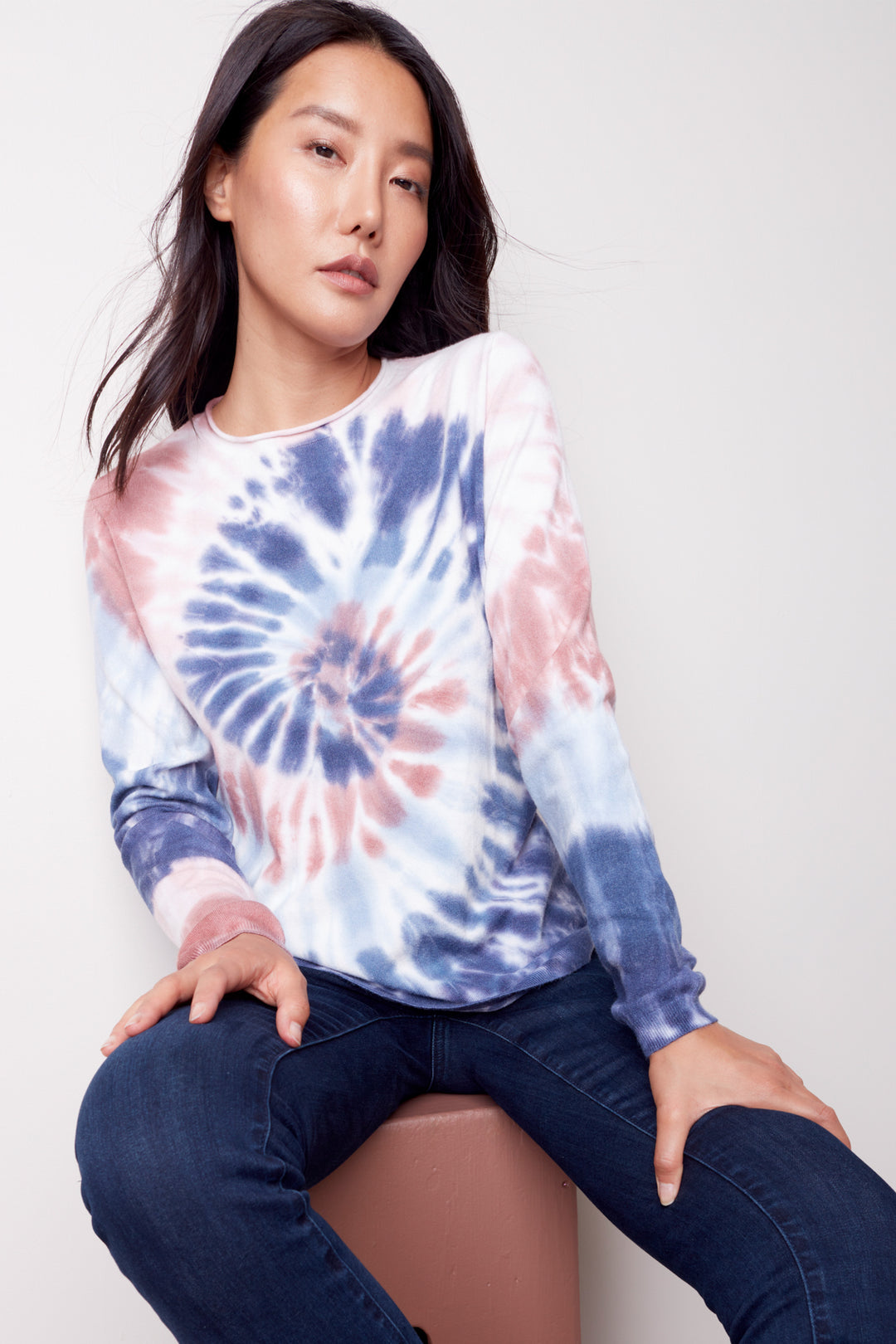 This Swirl Tiedye Long Sleeve Top features a classic crew-neck design with a vibrant tie-dye pattern and a round hem for a modern streetwear look.