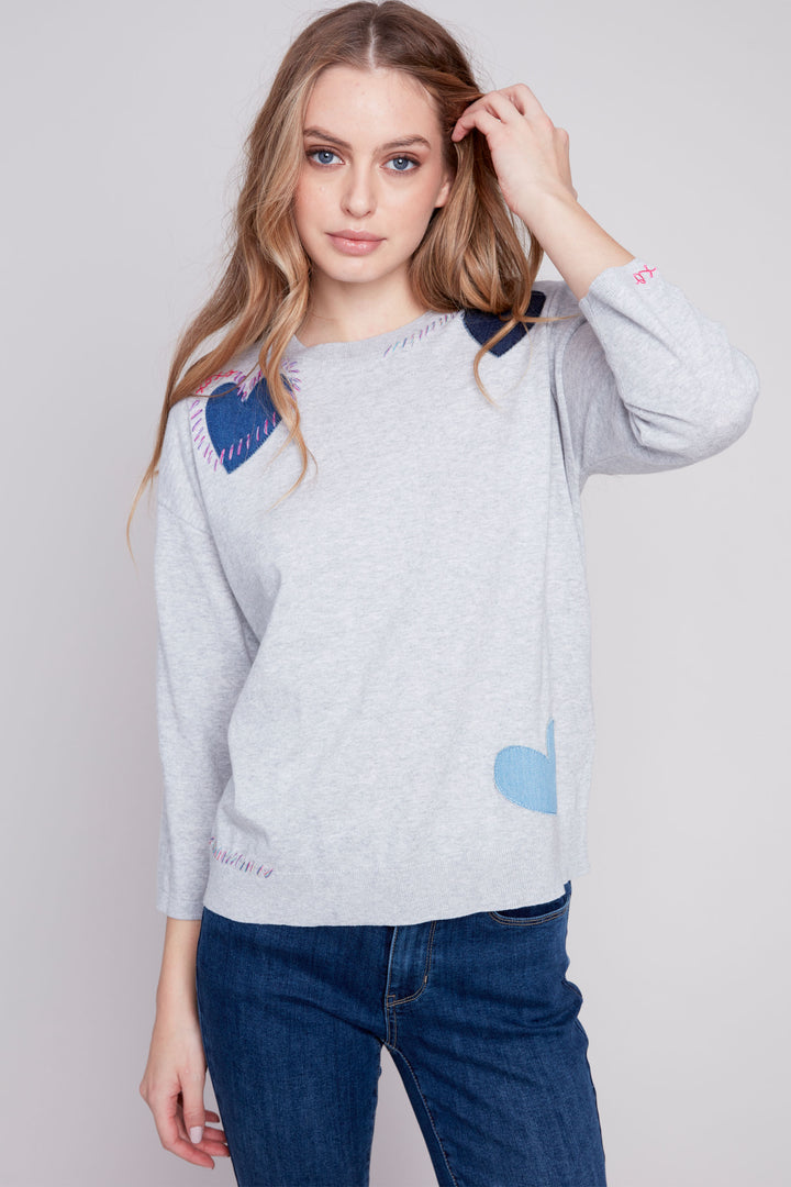 Made with all cotton for comfort, it features 3/4 length sleeves and unique stitched heart patches.