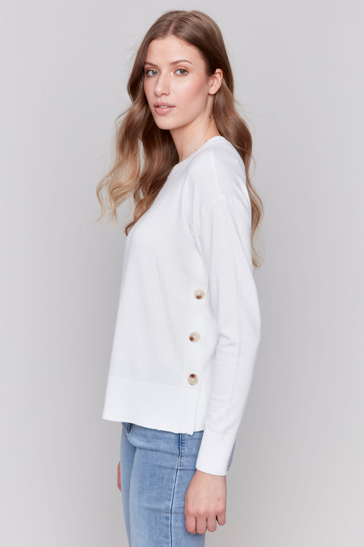 Charlie B Fall 2024 Expertly crafted with a soft blend of fabrics, this Long Sleeve Top features neat side buttons and a light sweater design. Perfect for a casual look paired with jeans, it offers both comfort and style.