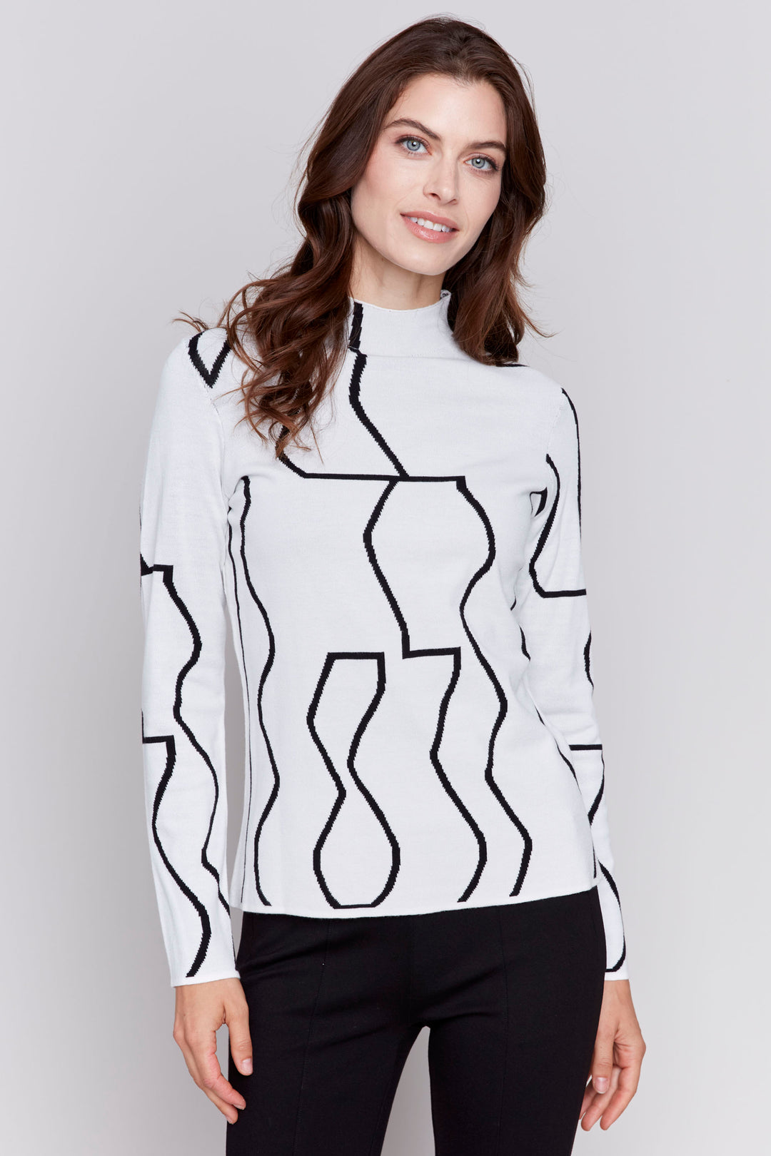 Charlie B Fall 2024 This mock neck sweater offers versatility with a 2 in 1 design, giving you the option to choose between a sleek black or crisp white! Its neat geometric print adds a touch of sophistication to the reversible jacquard fabric.