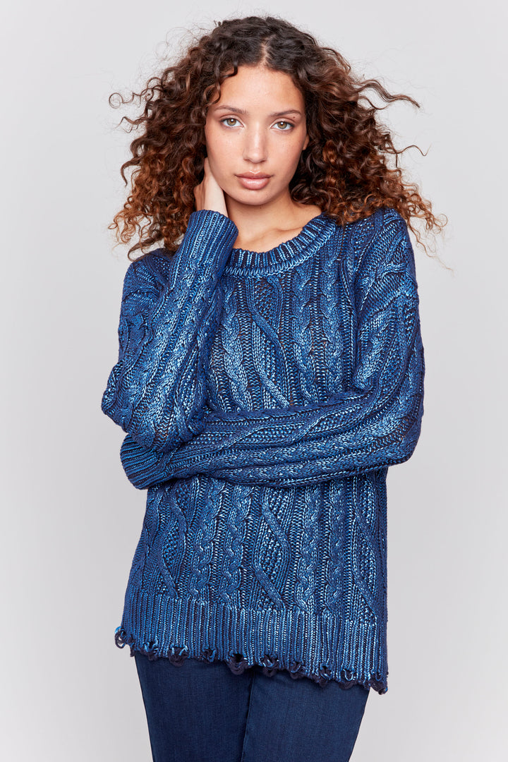 Charlie B Fall 2024 The slight fringe hem adds a touch of texture, while the full length sleeves and round neckline provide comfort and versatility. With a stunning foiled design finish, this top will elevate any outfit this fall.