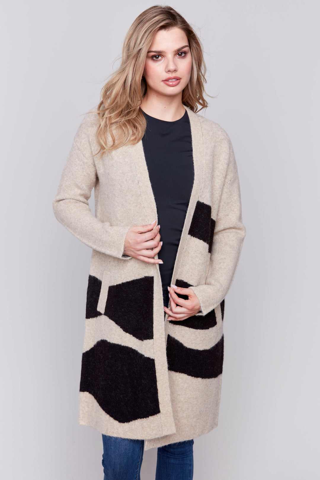 Charlie B Fall 2024  Featuring a Jacquard design and made of a long knit material, this cardigan is as fashionable as it is comfortable. 