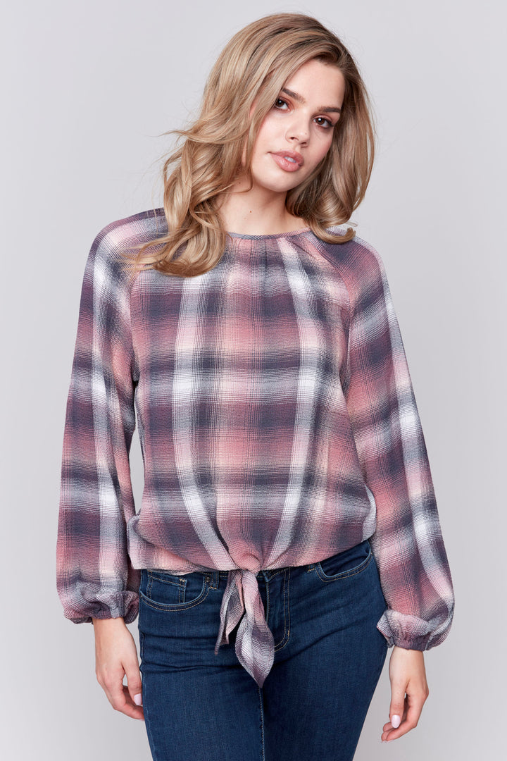 Charlie B Fall 2024  Featuring a classic round neck, a cute front knit tie and a cool plaid pattern, it's sure to bring effortless style to any outfit. Plus, its puffy long sleeves add a touch of drama. 