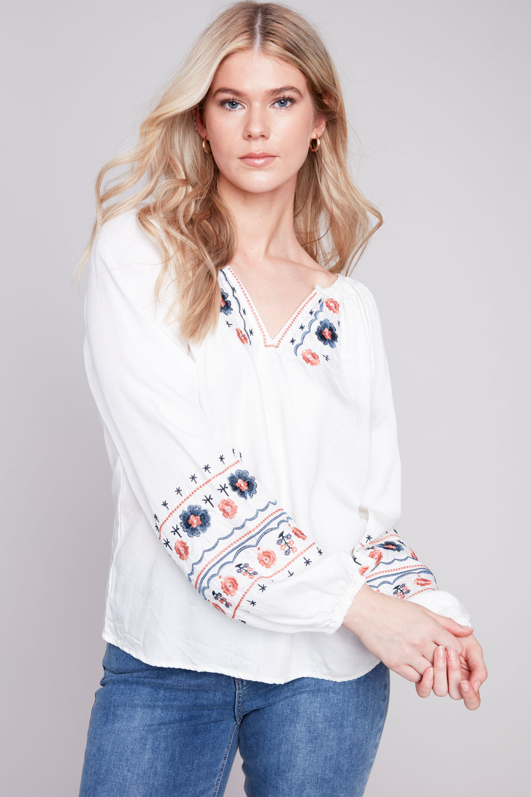 This lovely printed blouse features a unique v-neckline and wide full length sleeves with elastic cuffs for added comfort. 
