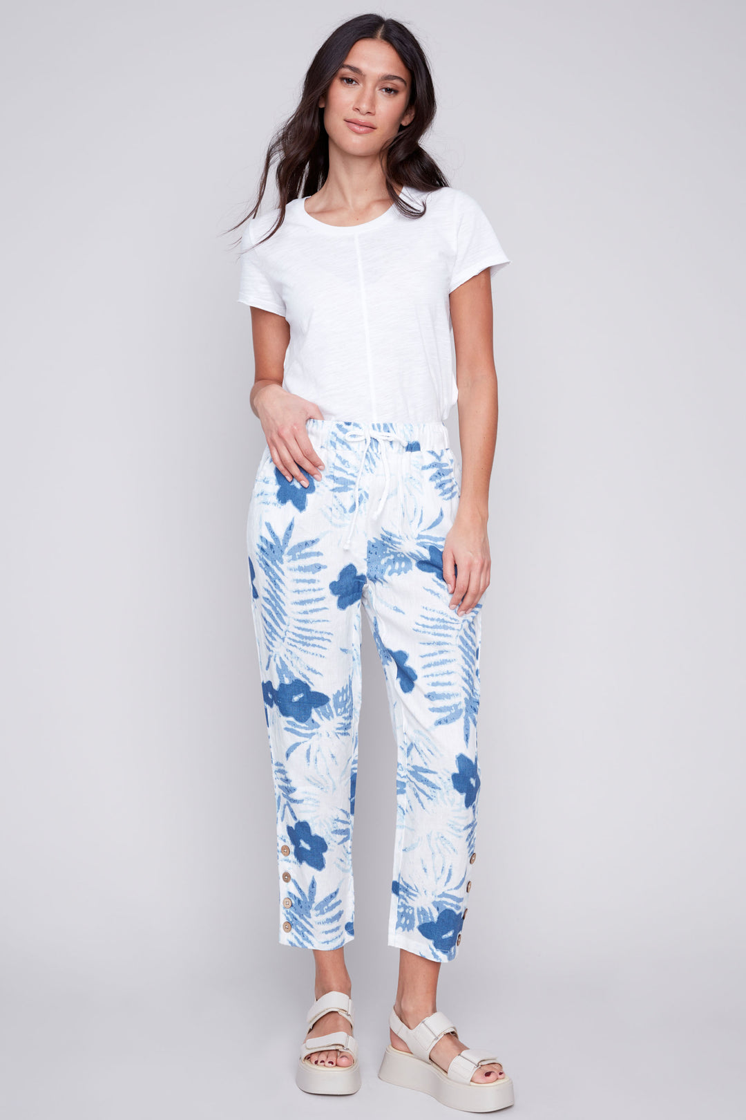 Charlie B Summer 2024 Made from all linen, these pants are light and soft for maximum comfort. The cropped length and tapered straight leg create a stylish silhouette, while the pull-on waist with drawstring and button detail at the hem add convenience. 