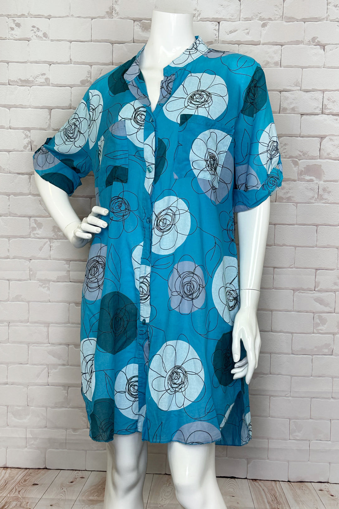 CHERISHH Spring 2024 Made of 100% cotton, this dress features a tunic collar and a neat floral print. The half sleeves and loose relaxed fit make it perfect for a day at the beach or as a casual house dress. 