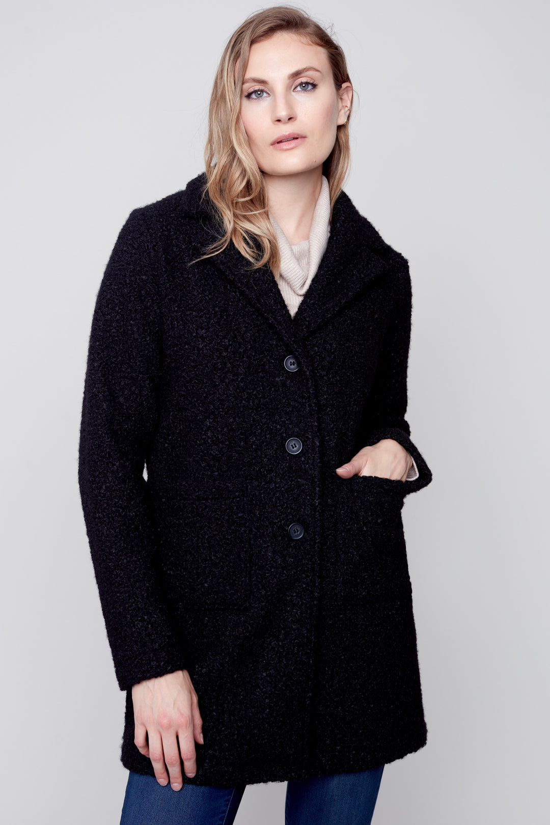 a luxurious bouclé knit coat tailored to provide a comfy and elegant look. This show-stopping piece has a tailored collar and two patch pockets, making it the ultimate fashion staple. 