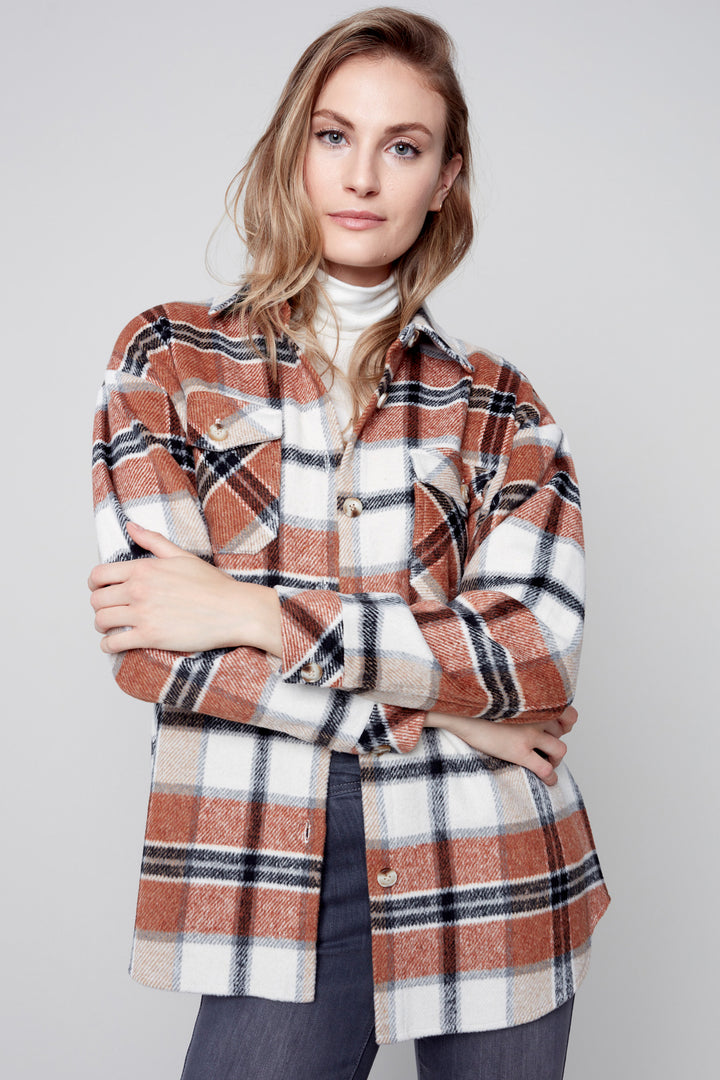 Stay cozy and look your best with this Plaid Shacket! Crafted from the softest plaid flannel, this shirt jacket features a button-down front and chest flap pockets for a classic look that will always be in fashion. Enjoy the perfect combination of comfort and style with this one-of-a-kind piece!