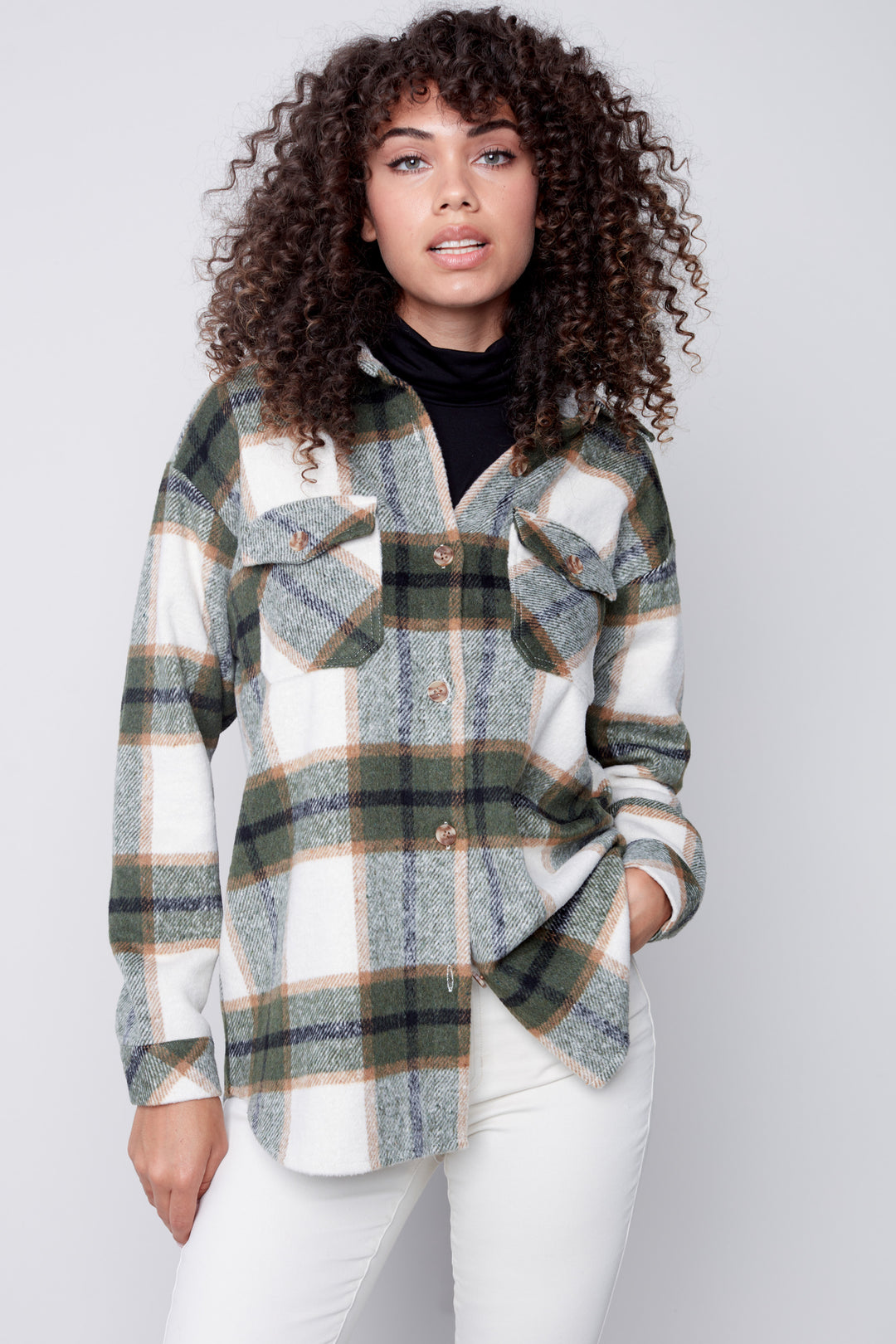 Crafted from plaid flannel fabric, this button front shirt jacket features two chest flap pockets that provide a secure place for your essentials.