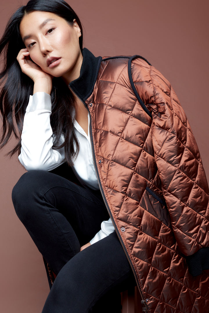Be ready for the cooler weather in style with this Iridescent Quilted Jacket. Featuring a long quilted puffer style, rib knit zipper-front closure and pockets, all in a bold, bright, vintage fall colour. Make a statement and stay warm this season!