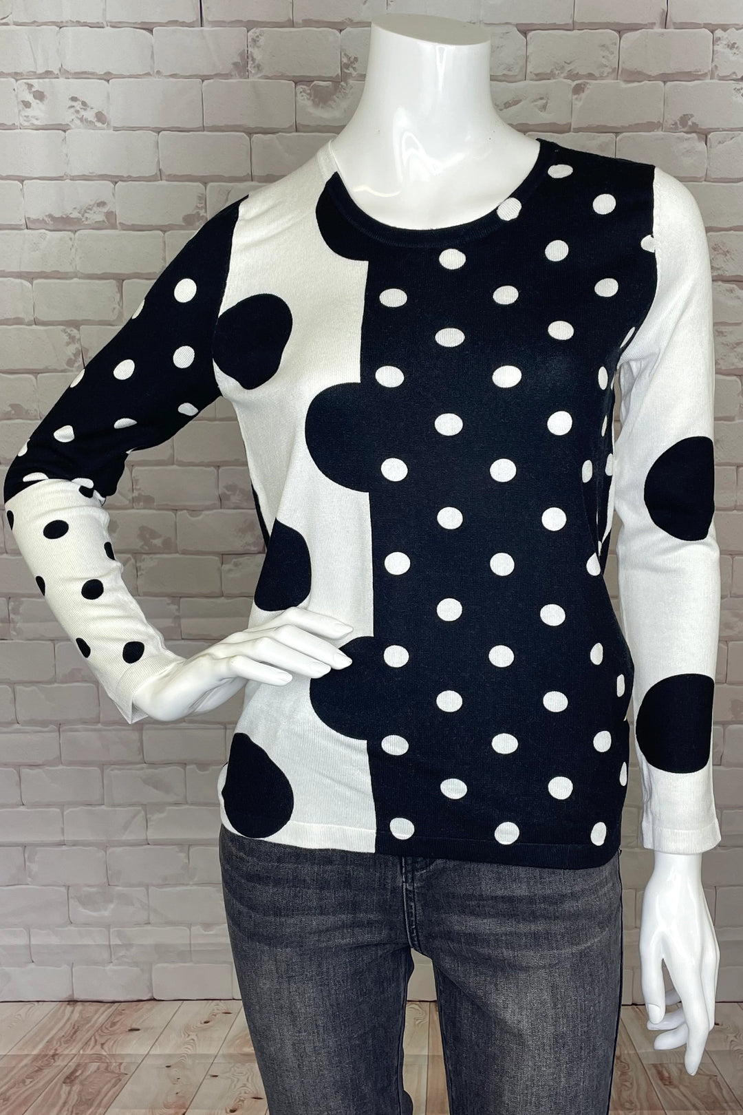 This lightweight, playful sweater features black and white dots of joy that will have you dazzling! 
