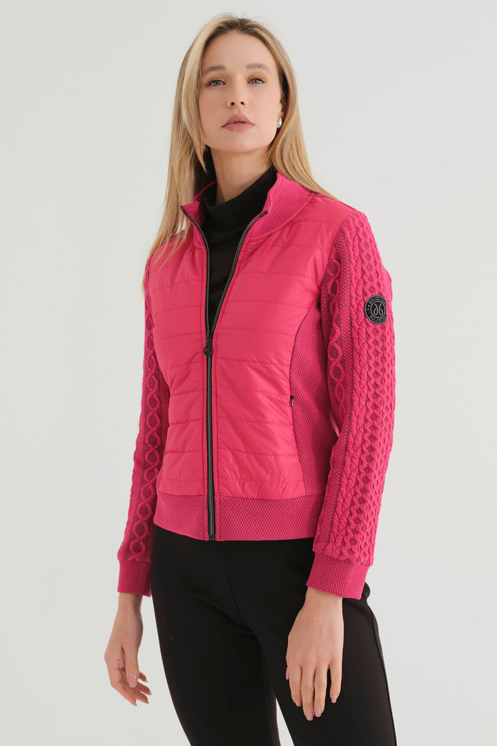 Dolcezza Fall 2024 This versatile Puffy Front Embossed Zip Jacket offers a sweater-like look and feel with an embossed cable knit pattern along the sleeves and a contrast puffy front. 