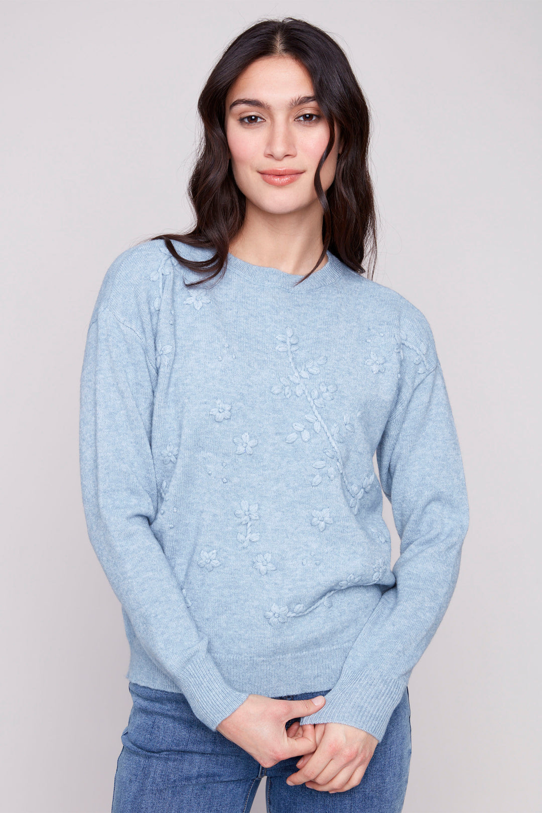 Charlie B Fall 2025 
Designed with a cozy crew neck, relaxed drop shoulders and a flattering round hemline, it offers comfort without compromising style. Perfect for layering or wearing on its own, this sweater seamlessly combines artistry with everyday wearability.