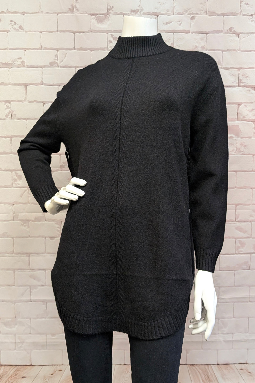 Etern Fall 2025 
This mock neck tunic with side buttons offers a perfect blend of cozy comfort and polished style. Its ribbed high neck and cuffs add subtle texture, while the light, loose fit and rounded hemline create a relaxed yet flattering silhouette. 
