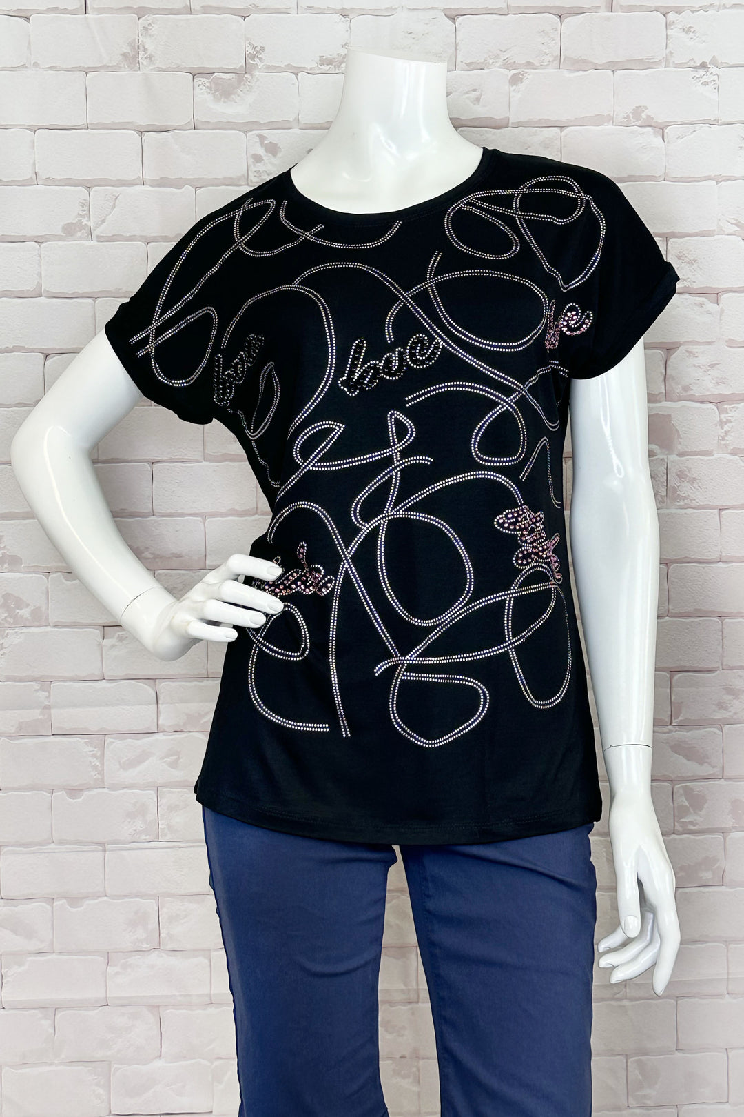 Ness Spring 2024 The round neckline and short sleeves make it easy and comfortable to wear, while the standout abstract love print on the front adds a touch of fun and playfulness to any outfit.