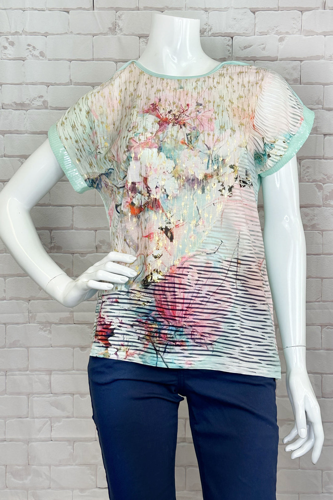 Ness Spring 2024 The round neckline and short sleeves make it easy and comfortable to wear, while the lovely mint watercolour spring floral print on the front adds a touch of fun and playfulness to any outfit. 