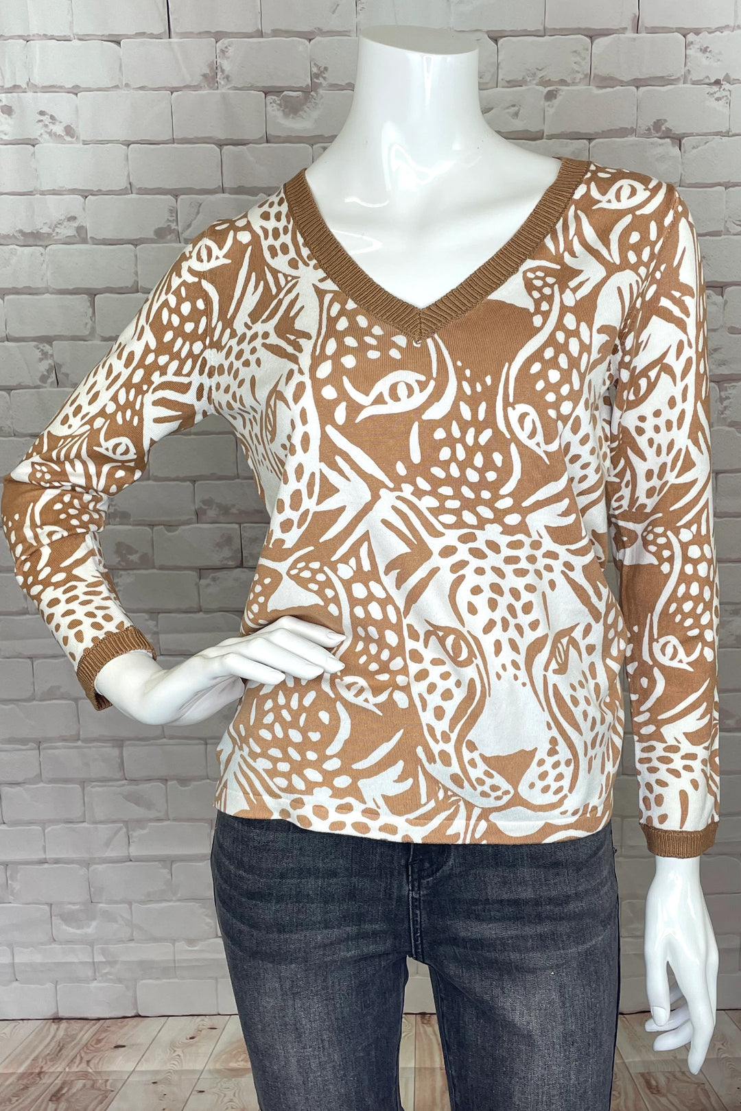 Vibrantly printed with the cheetah and an African motif overall, this camel-coloured sweater is sure to turn heads!