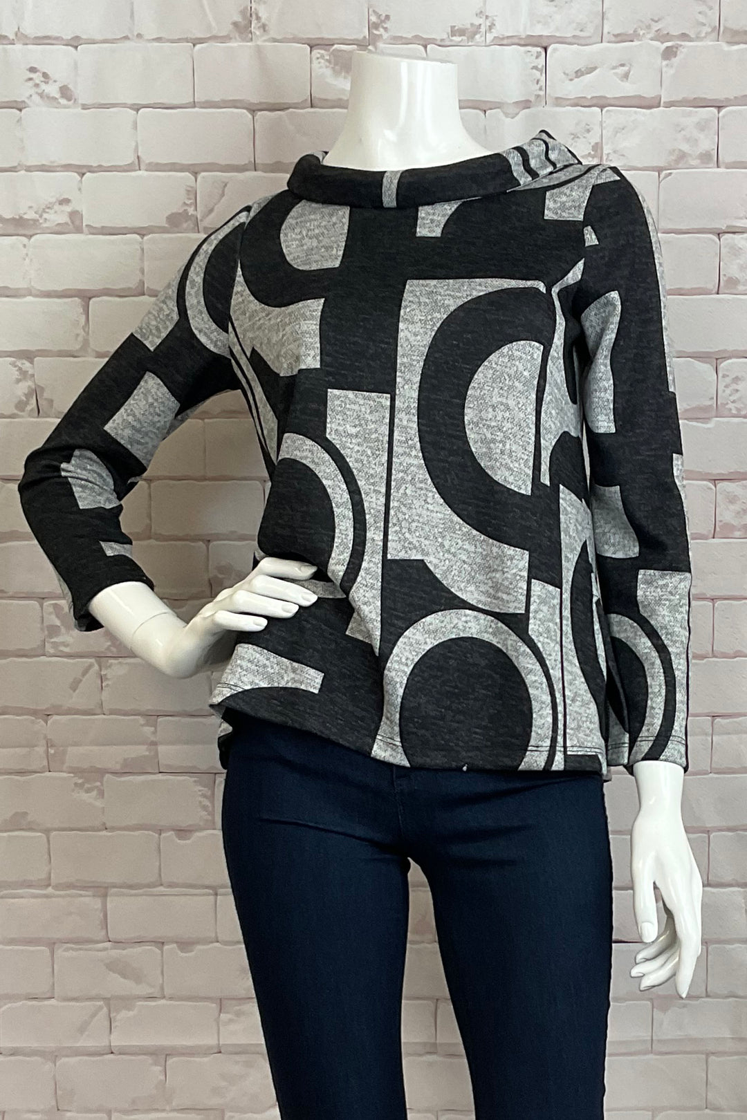 Michael Tyler Fall 2024  The neat black and silver circle print adds a touch of boldness, while the double stitch cuffs and hem provides durability. 