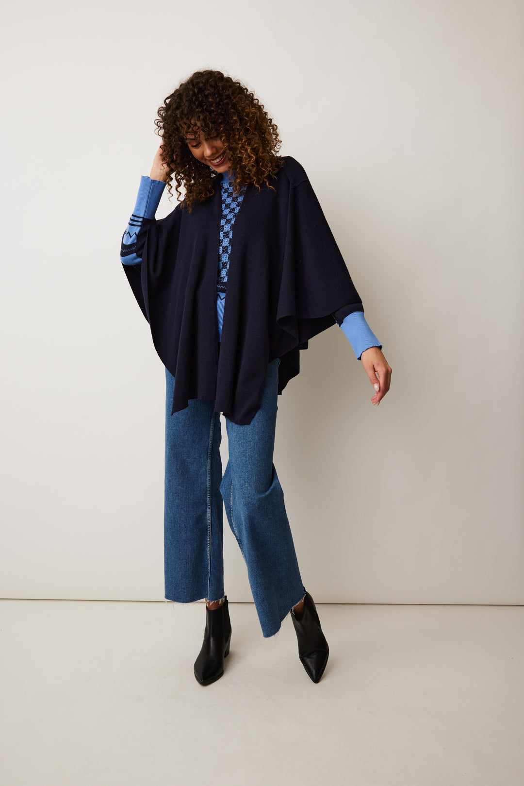 Crafted from a lush soft cotton, our lightweight shawl-style wrap adds a touch of elegance to any outfit, while the arm loops keep the wrap securely in place.